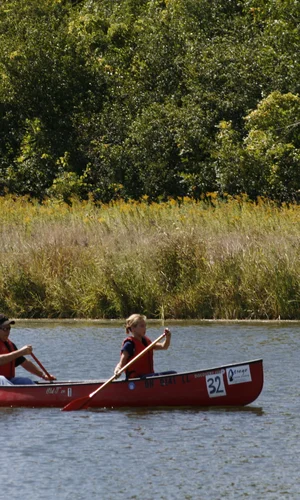Two paddlers steer their canoe through the WW Knight Nature Preserve pond.