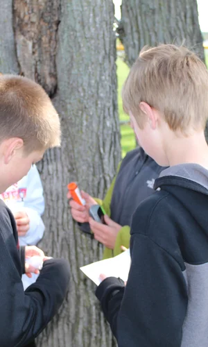 A team of young kids work together to find a Geocache.